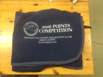 Folded 2016 Points Competition Embroidered on a rug on a table
